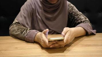 Woman wearing hair cover using smartphone video