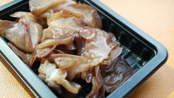 Cooked and seasoned ear mushroom in container video