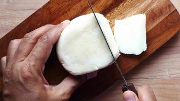 Slicing mozzarella cheese on wooden board video