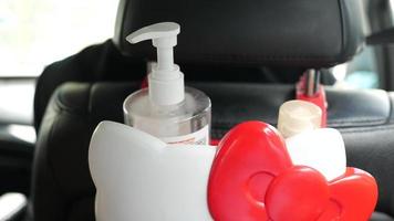 Back of car seat fitted with holder for hand sanitizer or lotions video
