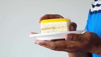 Man picks up a piece of layered cake off plate to eat video