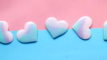 Colorful hearts on pink and bue background video