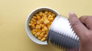 Pouring can of whole kernel corn into dish video