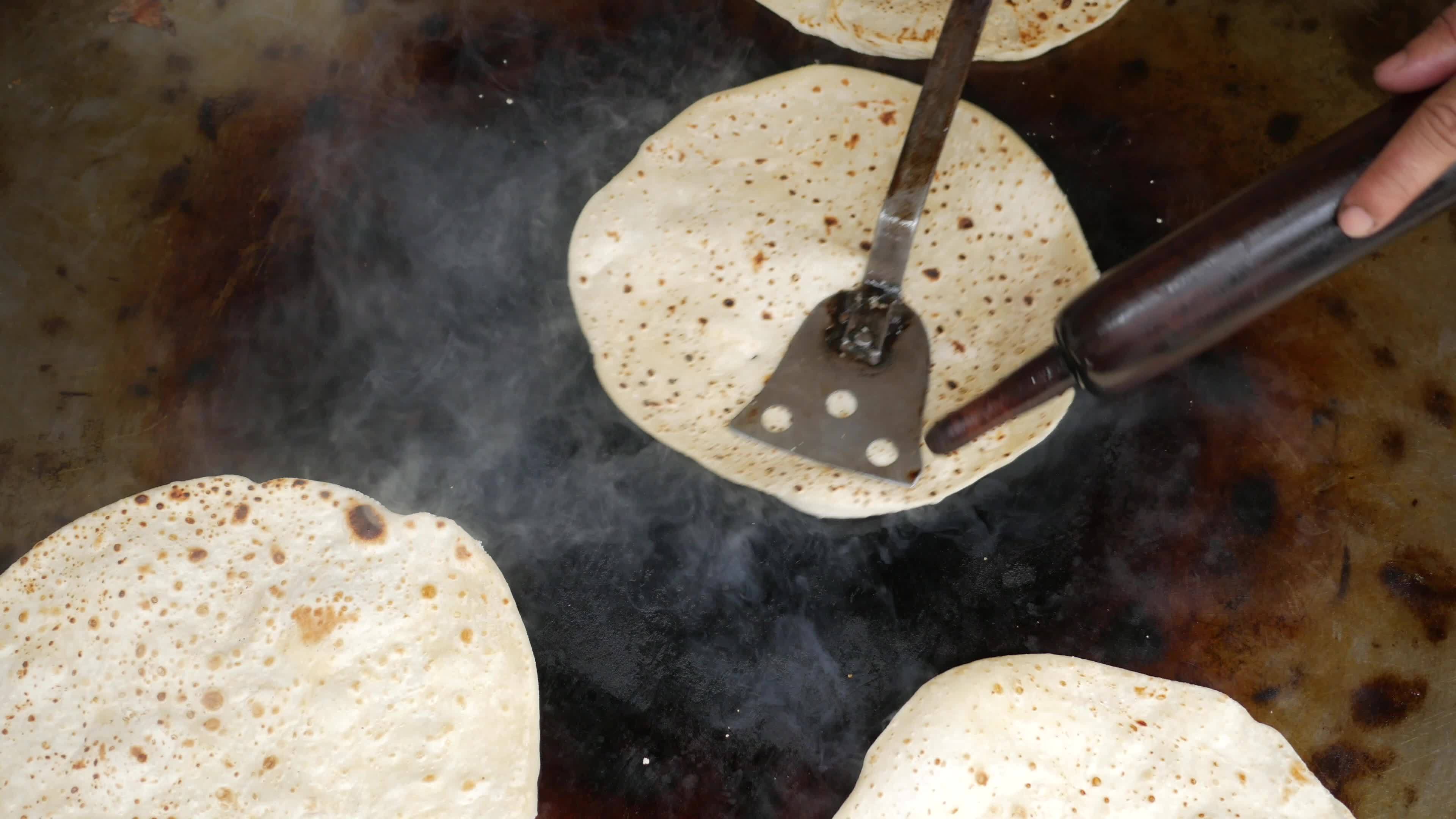 Heating up tortillas on a grill 13826730 Stock Video at Vecteezy