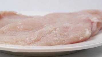 Raw chicken on a white plate video