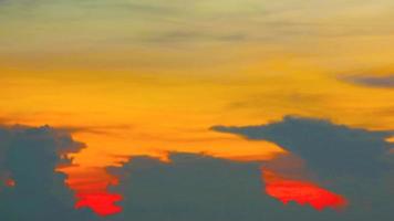 Blur sunset red yellow orange cloud on the sky over sea time lapse video