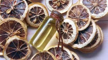 Dried slices of grapefruit, essencial oil in a rustic bottle video