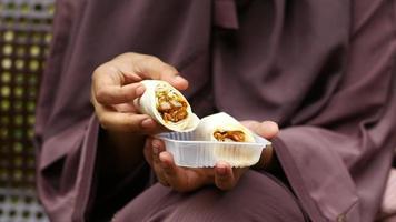 Woman in hijab eats a chicken burrito video