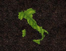 Italy map made of green leaves on soil background ecology concept photo