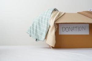 Concept of cloth donation. Putting old and un-use second hand shirt sending out for donation. photo