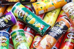 KHARKOV, UKRAINE - MARCH 30, 2021 Many Pringles cylinder chips boxes with varios colors and flavours. American brand of stackable potato-based crisps photo