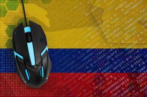 Colombia flag and computer mouse. Digital threat, illegal actions on the Internet photo