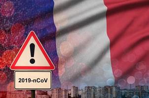 France flag and Coronavirus 2019-nCoV alert sign. Concept of high probability of novel coronavirus outbreak through traveling tourists photo