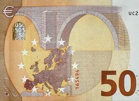 Fragment part of 50 euro banknote close-up with small brown details photo