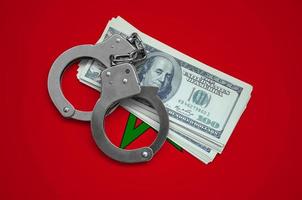 Morocco flag with handcuffs and a bundle of dollars. Currency corruption in the country. Financial crimes photo