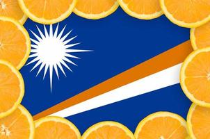 Marshall Islands flag in fresh citrus fruit slices frame photo