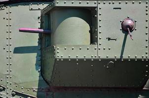 The texture of the wall of the tank, made of metal and reinforced with a multitude of bolts and rivets. Images of the covering of a combat vehicle from the Second World War with a guided machine gun photo