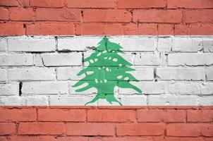 Lebanon flag is painted onto an old brick wall photo