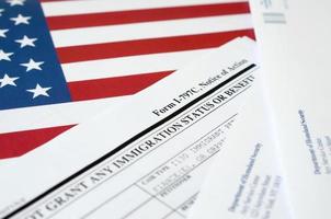 I-797c Notice of action blank form lies on United States flag with envelope from Department of Homeland Security photo