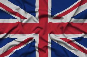 Great britain flag is depicted on a sports cloth fabric with many folds. Sport team banner photo