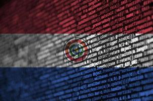 Paraguay flag is depicted on the screen with the program code. The concept of modern technology and site development photo