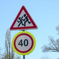 Road sign with the number 40 and the image of the children who run across the road photo