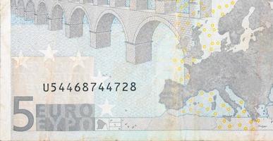 Fragment part of 5 euro banknote close-up with small brown details photo