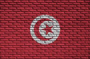 Tunisia flag is painted onto an old brick wall photo