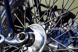 Fragment of chromed shiny wheel of old classic motorbike photo