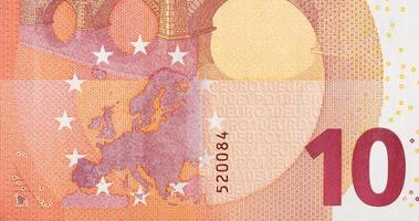 Fragment part of 10 euro banknote close-up with small red details photo