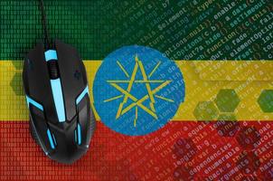 Ethiopia flag and computer mouse. Digital threat, illegal actions on the Internet photo