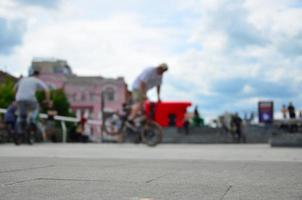 Defocused image of a lot of people with bmx bikes. Meeting of fans of extreme sports photo