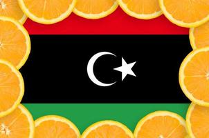 Libya flag in fresh citrus fruit slices frame photo