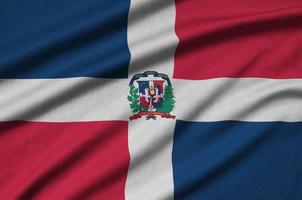 Dominican Republic flag is depicted on a sports cloth fabric with many folds. Sport team banner photo