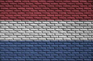 Netherlands flag is painted onto an old brick wall photo