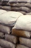 Background of many dirty sand bags for flood defense. Protective sandbag barricade for military use. Handsome tactical bunker photo