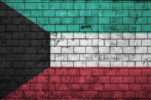 Kuwait flag is painted onto an old brick wall photo