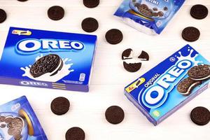 KHARKOV, UKRAINE - MAY 3, 2022 Oreo sandwich cookies and blue product boxes on white table. Oreo is a sandwich cookie with a sweet cream is the best selling cookie in the US photo