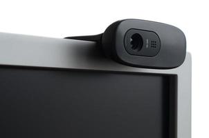 A modern web camera is installed on the body of a flat screen monitor. Device for video communication and recording of high quality video photo