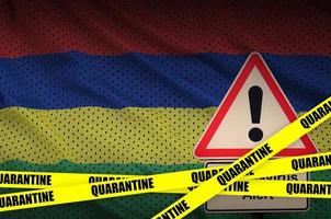 Mauritius flag and Covid-19 quarantine yellow tape. Coronavirus or 2019-nCov virus photo