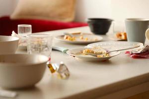 platos sucios vacíos con cucharas y tenedores en la mesa después de la comida. concepto de final de banquete. platos sin lavar foto