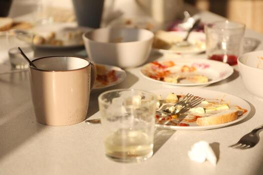Empty dirty plates with spoons and forks on the table after meal. Banquet ending concept. Unwashed dishes photo