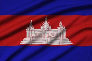 Cambodia flag is depicted on a sports cloth fabric with many folds. Sport team banner photo