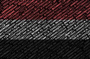 Yemen flag is depicted on the screen with the program code. The concept of modern technology and site development photo