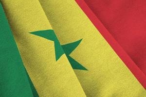 Senegal flag with big folds waving close up under the studio light indoors. The official symbols and colors in banner photo