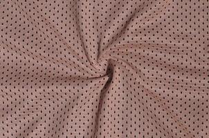 Texture of sportswear made of polyester fiber. Outerwear for sports training has a mesh texture of stretchable nylon fabric photo