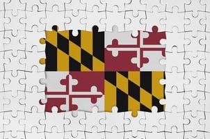 Maryland US state flag in frame of white puzzle pieces with missing central part photo