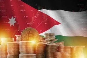 Jordan flag and big amount of golden bitcoin coins and trading platform chart. Crypto currency photo
