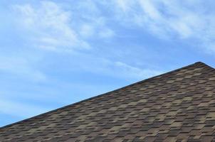 The roof covered with a modern flat bituminous waterproof coating under a blue sky photo