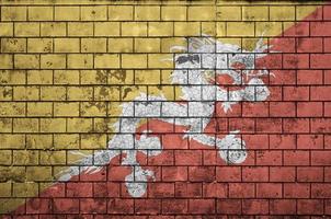 Bhutan flag is painted onto an old brick wall photo